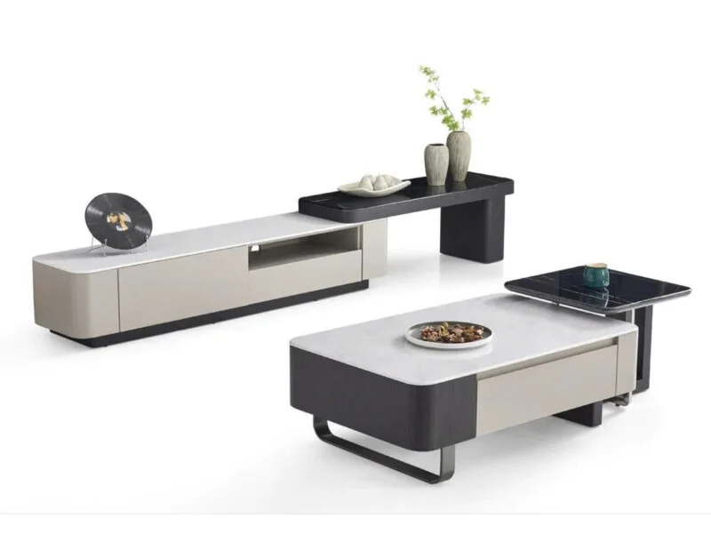 Bộ sản phẩm gồm bàn trà hình chữ nhật và kệ tivi phong cách hiện đại, đặt trên nền trắng. Bàn trà có mặt đá vi tinh thể mà…