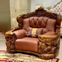 Cận cảnh ghế sofa đơn trong bộ sưu tập, chụp từ góc hơi chếch. Ghế có khung gỗ mun Nam Phi chạm khắc hình cá chép và hoa v…