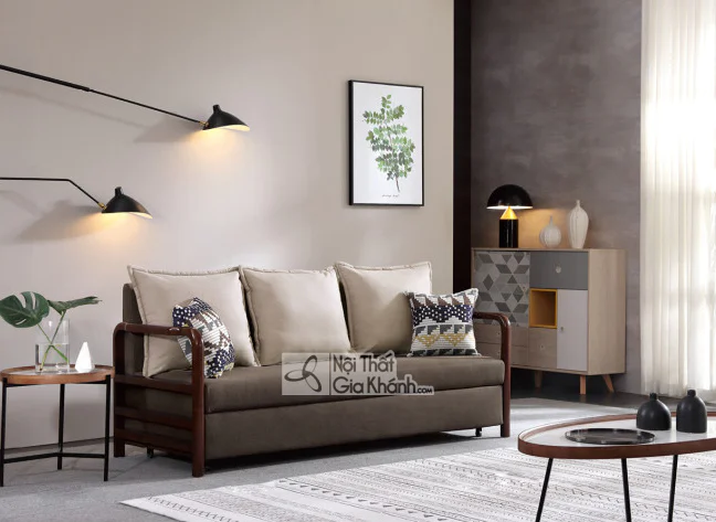 Sofa giường băng 3 SF273A-8G chụp góc chếch trong phòng khách hiện đại. Sofa có khung gỗ nâu sẫm lộ ở tay vịn và chân, bọc…