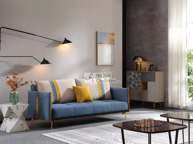 Sofa giường SF197-2G màu xanh dương đậm, đặt trong không gian phòng khách hiện đại. Sofa có thiết kế băng dài, tựa lưng và…