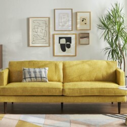 Sofa băng 3 chỗ Preston SF-111 màu vàng mustard nổi bật, bọc vải, đặt trong phòng khách hiện đại. Sofa có chân gỗ thon, kế…