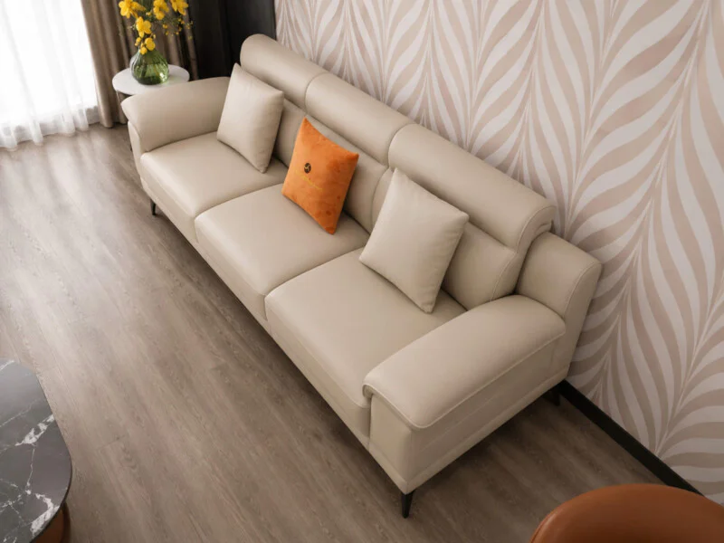 Cận cảnh sofa băng dài của bộ Belluno SB01, chất liệu da màu kem nhạt, thiết kế tay vịn thấp và tựa lưng êm ái, có gối tựa…