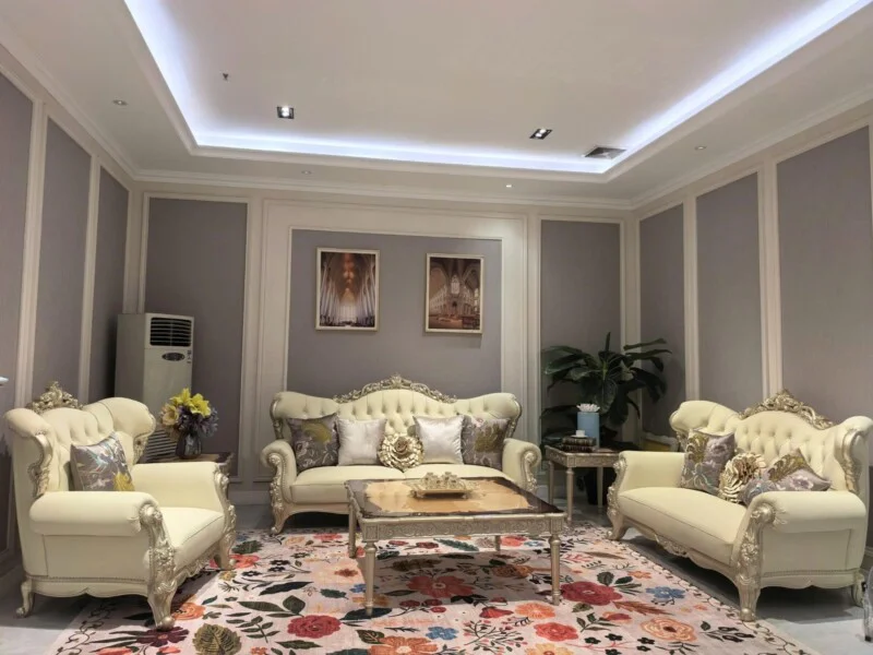 Bộ sofa PALAIS D'OR tân cổ điển luxury màu kem được đặt trong phòng khách sang trọng. Góc chụp chính diện, bao gồm một ghế…